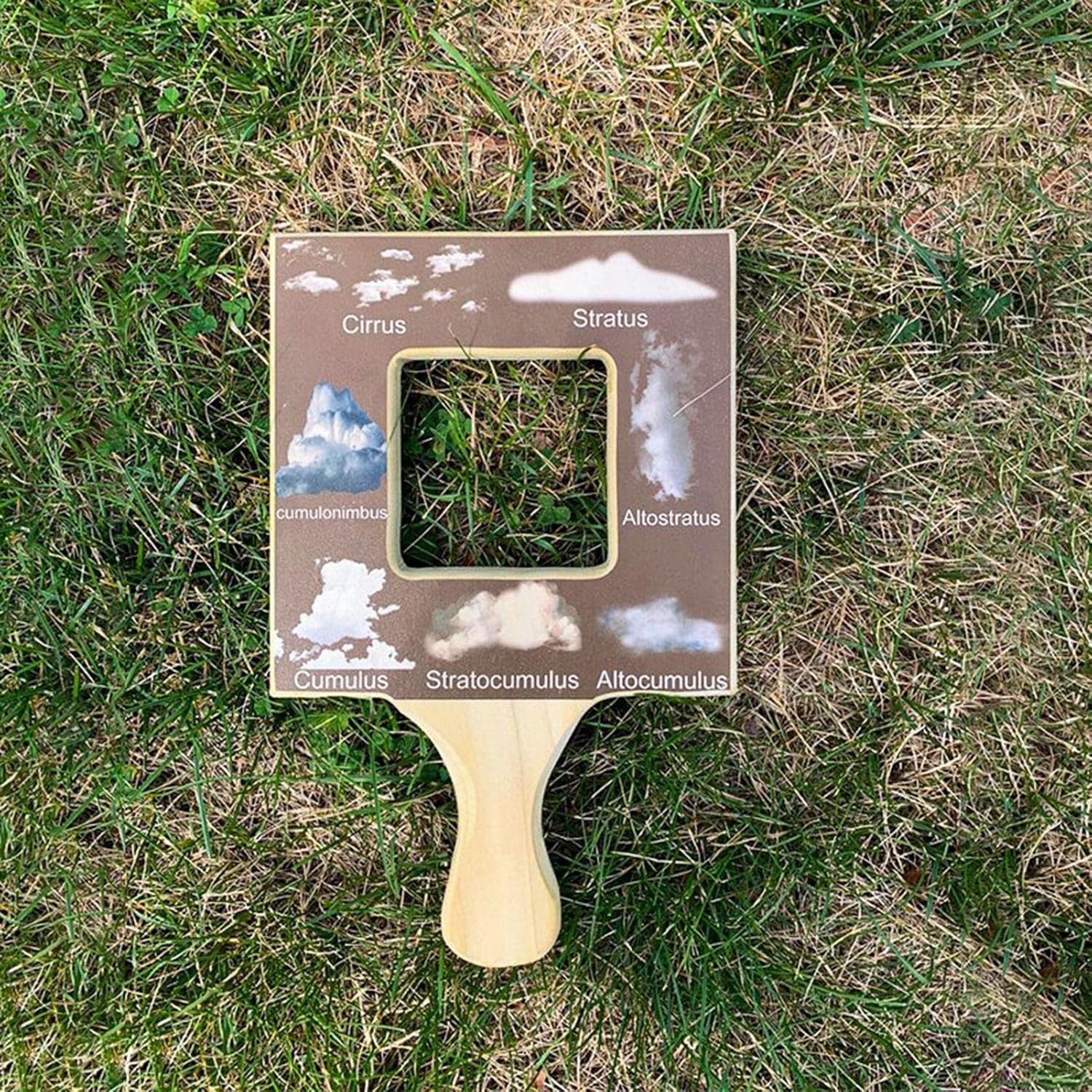child using wooden nature guide finder during outdoor exploration and learning activity